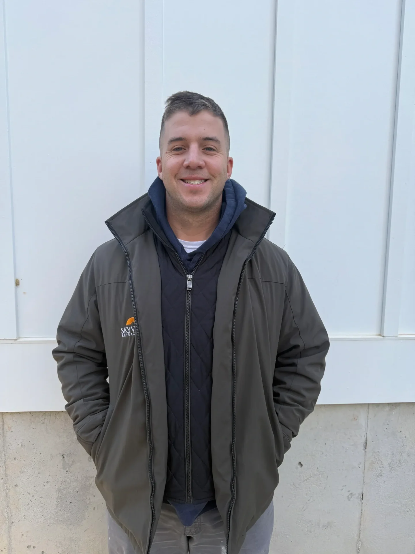 A man wearing jacked and standing